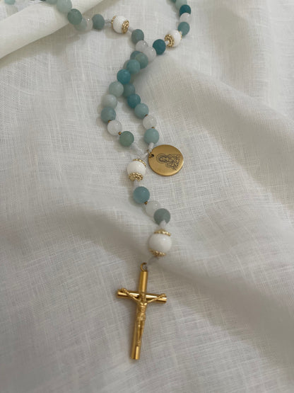 Handmade Catholic rosary featuring semi-precious amazonite stones, a gold Miraculous medal, and a gold crucifix on a minimal linen background.