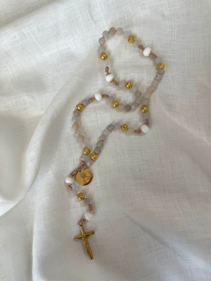 Handmade Catholic rosary with a gold Jesus medal and sleek gold crucifix hand-knotted on a modern leather cord.