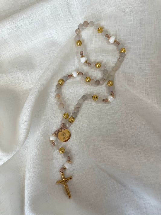 Handmade Catholic rosary with a gold Jesus medal and sleek gold crucifix hand-knotted on a modern leather cord.